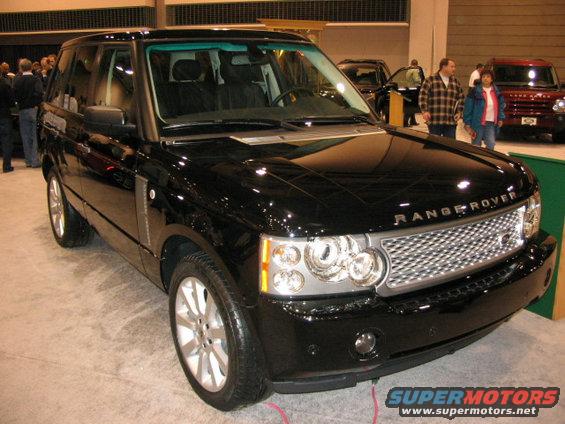 Black Range Rover SUV with chrome grille and headlights. Text on grille reads RANGE ROVER. Supermotors.net logo at bottom right