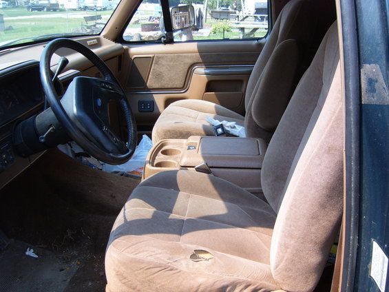 Tan interior with bucket seats, center console, and steering wheel