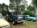 1996 Ford Bronco - Two classic Ford vehicles, a Bronco and a Falcon, parked outdoors on a cloudy day.