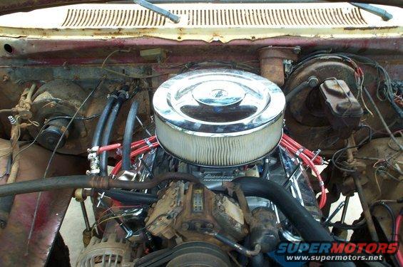 engine bay showing V8 engine, chrome air cleaner, and red spark plug wires
