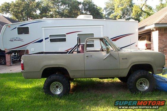 Tan 1978 Dodge Power Ram pickup truck, side view, with roll bar, lifted suspension, and aftermarket wheels