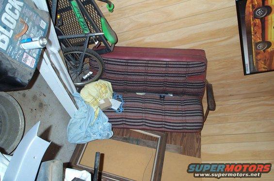 Striped vehicle seats and a bicycle wheel inside a garage