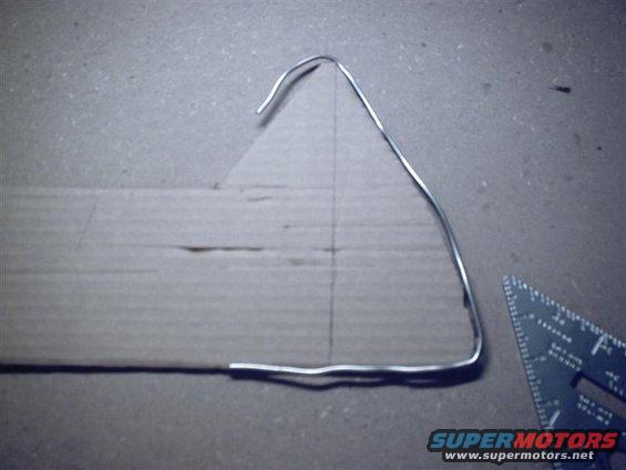 sunp0143-(medium).jpg So then we take the silver solder and lay it on a piece of cardboard and trace it. Here we have the entire passenger side forward panel already cut, with the silver solder showing that our contour matches.