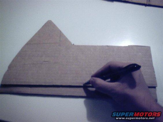 Now with both pieces on a semi-flat surface (like, say, the hood of your xj), line them up using the line you drew. 

Flip them over and draw the line where the bottom of the original meets your patch panel.