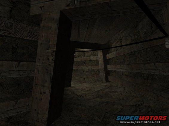 Interior of a dark, wooden mine shaft with support beams and rough wooden walls