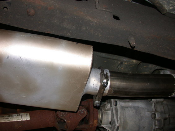 Exhaust muffler and pipe clamped to transmission housing on a 1995 Ford Bronco