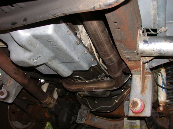 Underside view of vehicle exhaust pipes and transmission pan