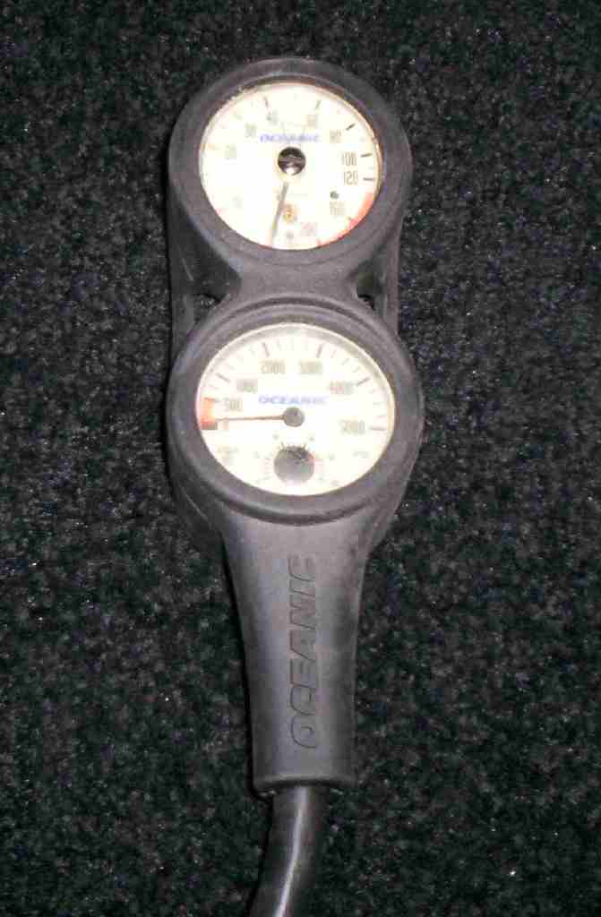 Two Oceanic diving pressure gauges, one for air pressure and one for depth