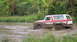 1979 Ford Bronco - A driver navigates a muddy terrain in a classic Ford Bronco, splashing through the mire.