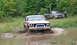 1979 Ford Bronco - Two 4x4 vehicles, a Bronco and an F-Series truck, navigate a muddy off-road course.