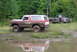 1979 Ford Bronco - This 1979 Ford Bronco navigates a muddy off-road course alongside a pickup truck.