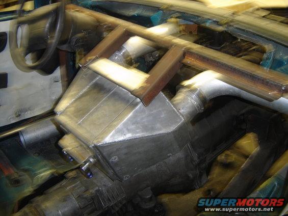 Custom interior with roll cage, large metal box, and steering wheel