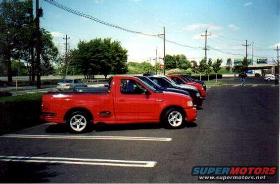 Red 1999 Ford F-150 Lightning pickup truck parked in a lot
