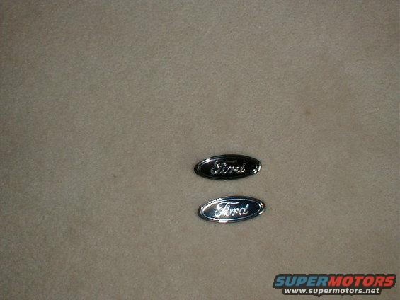 Two Ford oval emblems, one black, one chrome