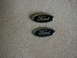 2002 Ford Crown Victoria - Two Ford emblems are shown against a textured background.
