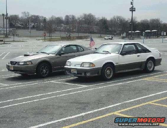 1989 Ford Mustang GT and a later model Mustang parked side-by-side in a parking lot