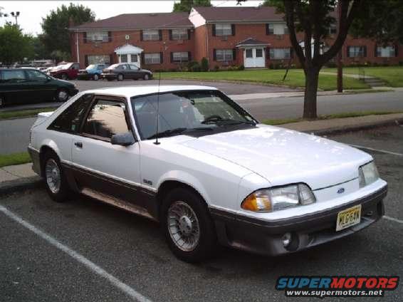 White 1989 Ford Mustang GT parked in a lot, front 3/4 view