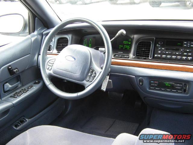 2002 Ford Crown Victoria interior showing dashboard, steering wheel, and center console with radio