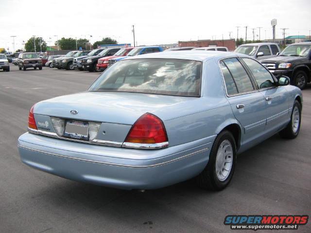 Light blue 2002 Ford Crown Victoria parked in a lot with other cars