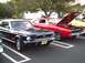 1989 Ford Mustang - A classic Mustang convertible is parked at an outdoor car show next to a Dodge Charger.
