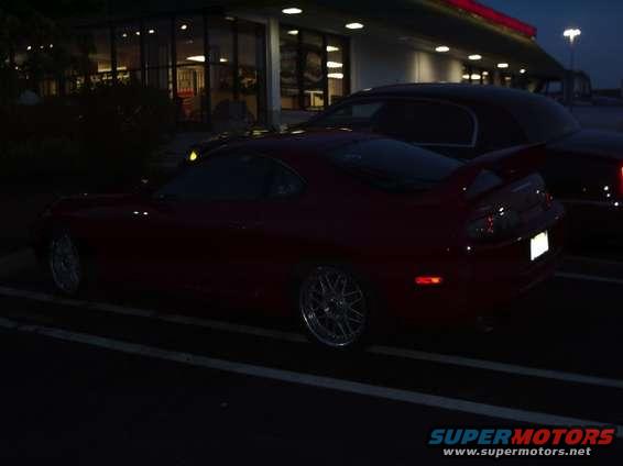 Red sports car side view at night