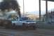 1994 Ford F-150 - A diesel truck is seen during a pull event, emitting a large cloud of black smoke.