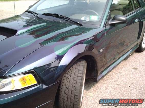 Dark green car with flame graphics, GT badge visible
