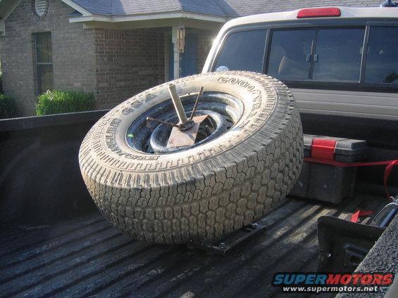 Spare tire and toolbox in the bed of a pickup truck
