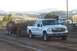 1994 Ford F-150 - White pickup truck competes in a pull event, with another truck visible in the background.