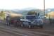 1994 Ford F-150 - A Dodge Ram pickup truck competes in a truck pull event, dragging a sled across a dirt track.