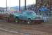1994 Ford F-150 - A lifted Ford F-150 truck competes in a truck pull event, with spectators in the background.