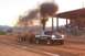 1994 Ford F-150 - GMC pickup truck competes in a tractor pull event, emitting a large cloud of black smoke.