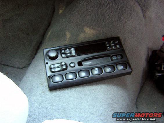 Face removed from stock radio, dremeled out and
some face buttons glued back on.  The eject button fell off temporarily.