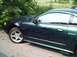 1989 Ford Mustang - This 2001 Ford Mustang GT features a dark green paint job with purple flame decals along the side.