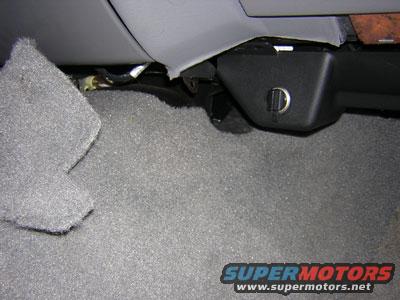 sirius4.jpg Carpet is pulled back to aid in removing the lower plastic panel.