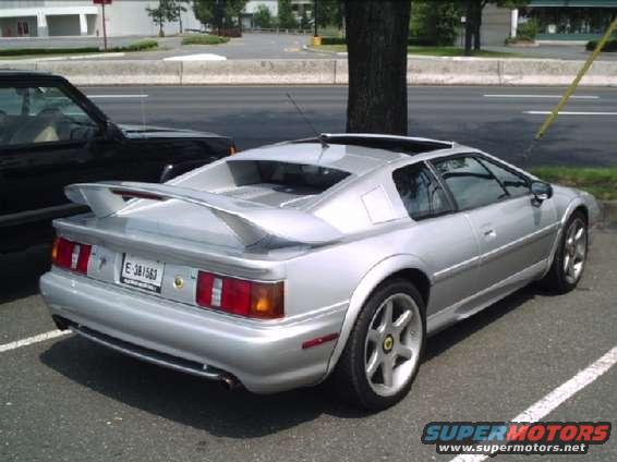 Silver sports car rear view with spoiler and custom wheels