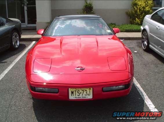 Red Chevrolet Corvette C4 with pop-up headlights and a New Jersey license plate