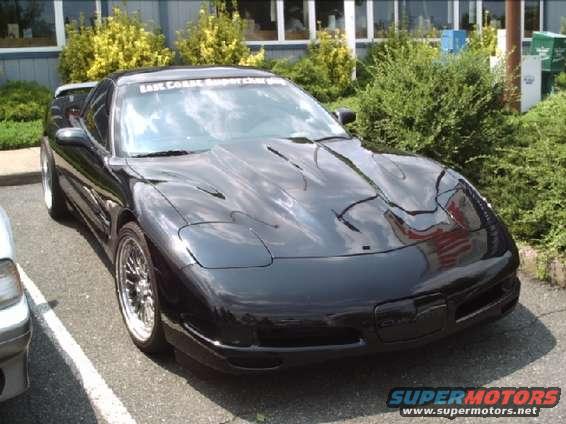Black Chevrolet Corvette C5 parked in a lot, front 3/4 view