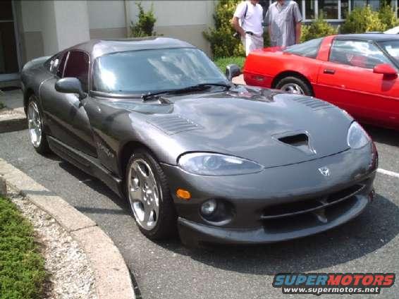 Gray Dodge Viper sports car parked next to a red car