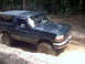 1996 Ford Bronco - This 1996 Ford Bronco is navigating a muddy off-road path.