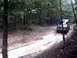 1996 Ford Bronco - A Ford Bronco navigates a wet, wooded trail.