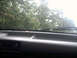 1996 Ford Bronco - View from the driver's seat through the windshield, with trees visible beyond the dashboard.