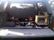 1996 Ford Bronco - The cargo area of an SUV is filled with various items, including tools and a wooden crate.
