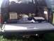 1996 Ford Bronco - The cargo area of a 1996 Ford Bronco contains various items including a wooden crate and a black case.