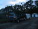 1995 Ford C-350 (Centurion Conversions) - This 1995 Ford C-350 Centurion Conversions SUV is seen towing a trailer in an outdoor setting.