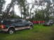 1995 Ford C-350 (Centurion Conversions) - A dark green Ford Bronco SUV is parked on the grass with another SUV in the background.