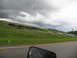 1995 Ford C-350 (Centurion Conversions) - A line of cars travels on a highway as dark storm clouds gather overhead.