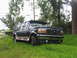 1995 Ford C-350 (Centurion Conversions) - 1995 Ford C-350 Centurion Conversions SUV parked on grass with trees in the background.