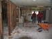 1995 Ford C-350 (Centurion Conversions) - Demolition work is underway inside a building, with debris scattered across the floor and walls partially dismantled.
