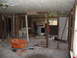 1995 Ford C-350 (Centurion Conversions) - Workers are in the process of demolishing an interior space, with debris scattered on the floor.